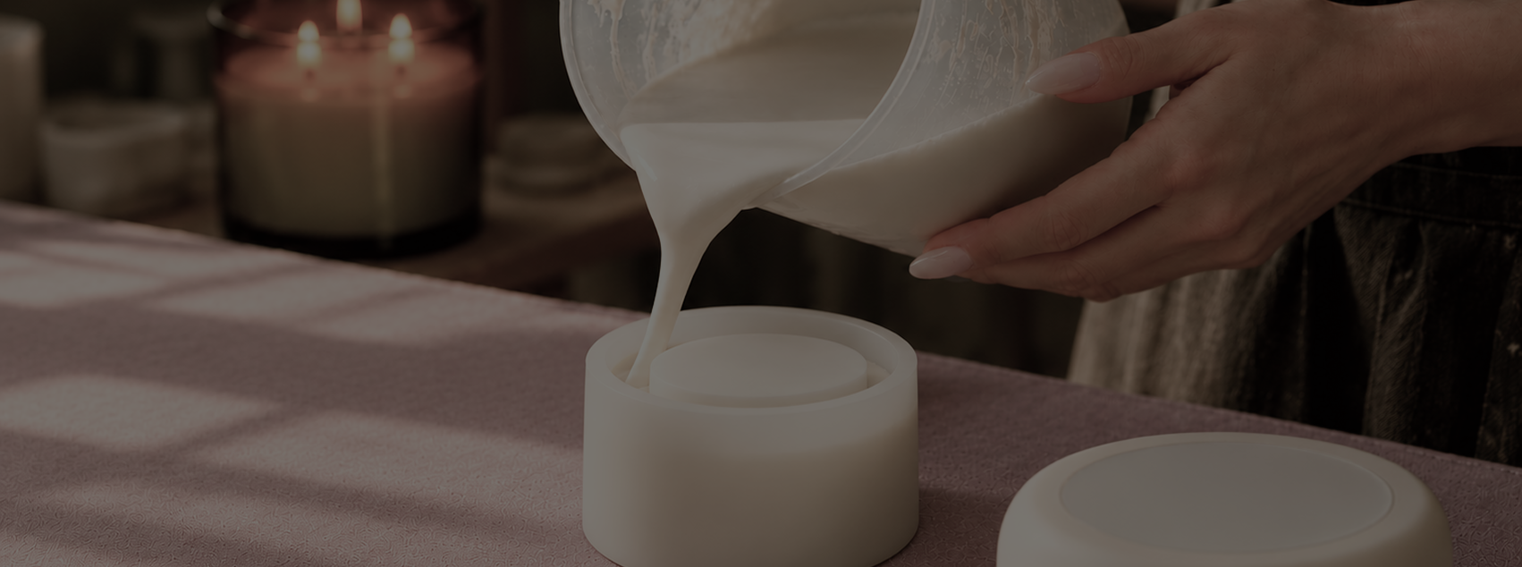 Wax being poured by hand into a candle vessel